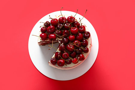 Tasty cherry cake on red backgroundの写真素材