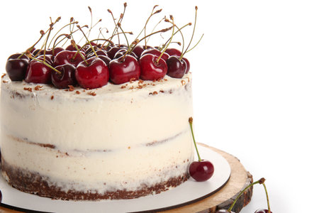 Wooden board with tasty cherry cake isolated on white backgroundの写真素材