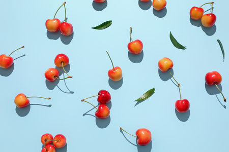 Many sweet cherries on blue backgroundの写真素材