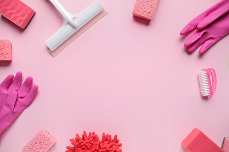 Frame made of different cleaning supplies on pink backgroundの写真素材