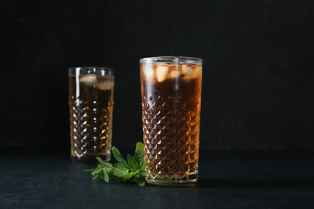 Glasses of ice tea with mint on black backgroundの写真素材