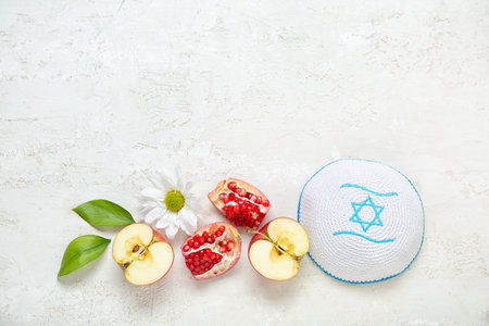 Composition with kippah, fresh fruits, flower and plant leaves on light background. Rosh hashanah (Jewish New Year) celebrationの写真素材