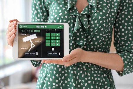 Young woman with smart home security system control panel, closeupの写真素材