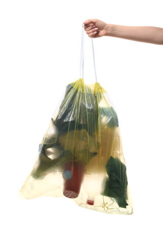 Female hand holding full garbage bag isolated on white backgroundの写真素材