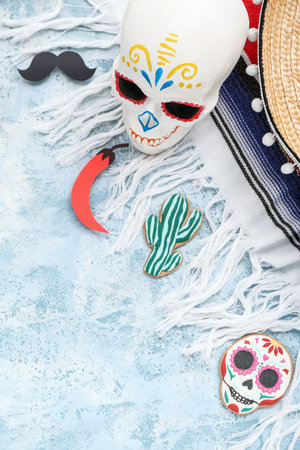 Painted skull with paper mustache, chili pepper, cookies and serape on grunge backgroundの写真素材