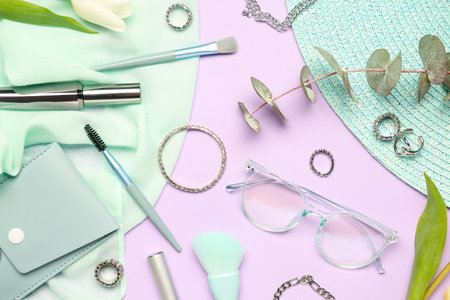 Composition with stylish female accessories and cosmetics on color backgroundの写真素材