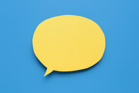 Blank paper speech bubble on blue backgroundの写真素材