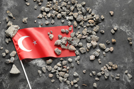 Stone debris with Turkish flag on dark background. Turkey earthquake conceptの写真素材
