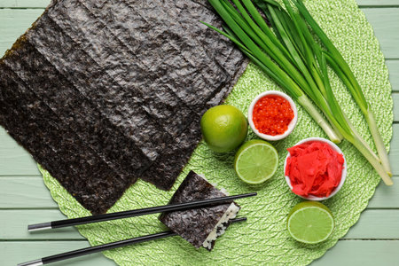 Nori sheets, caviar, ginger and lime on green wooden backgroundの写真素材