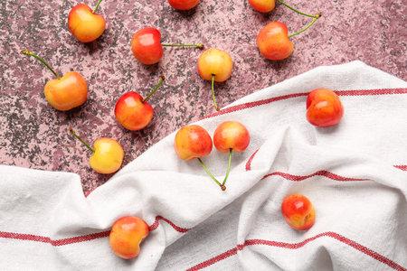 Many sweet yellow cherries on purple backgroundの写真素材