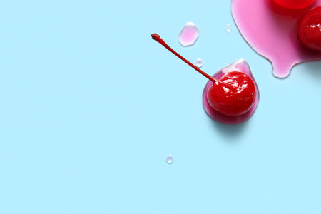 Tasty maraschino cherry on blue backgroundの写真素材