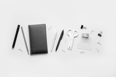 Set of different stationery with notebook on light backgroundの写真素材
