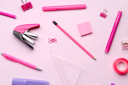Composition with stationery supplies on pink background