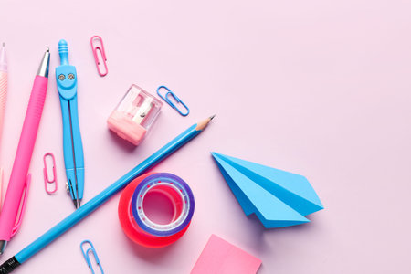 Composition with stationery supplies on pink background