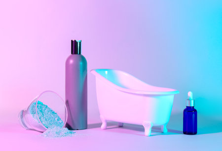 Small bathtub and cosmetic products on color backgroundの写真素材