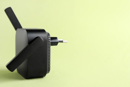 Black WiFi repeater on green backgroundの写真素材