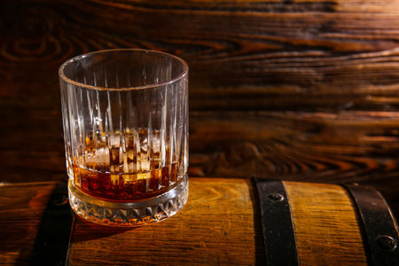 Barrel with glass of cold rum on wooden backgroundの写真素材