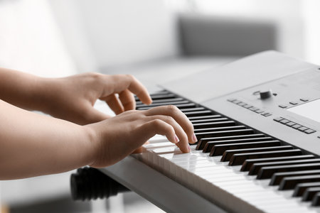 Woman playing modern synthesizer, closeupの写真素材