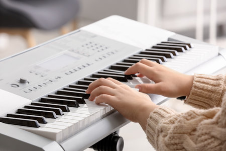 Woman playing modern synthesizer, closeupの写真素材