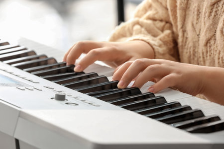 Woman playing modern synthesizer, closeupの写真素材