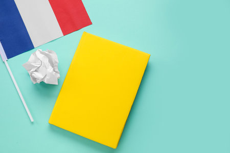 Flag of France with notebook and crumpled paper on green backgroundの写真素材