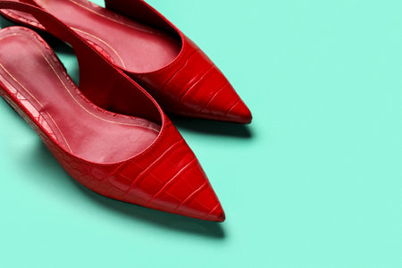 Pair of stylish red shoes on color backgroundの写真素材