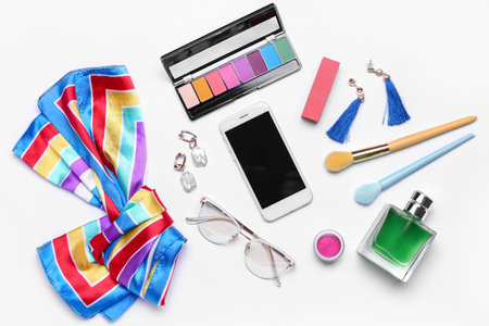 Composition with modern mobile phone, cosmetics and female accessories on white backgroundの写真素材