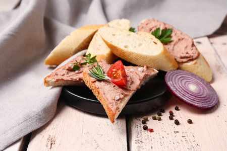Plate of delicious sandwiches with pate on light wooden backgroundの写真素材