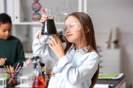 Little girl with conical flask in science classroomの写真素材