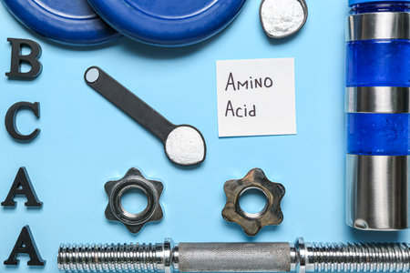 Composition with sports equipment, amino acid supplement and bottle of water on color background, closeupの写真素材
