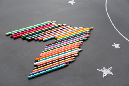 Pencils and drawn stars on black backgroundの写真素材