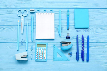 Blank notebook and stationery on blue wooden backgroundの写真素材
