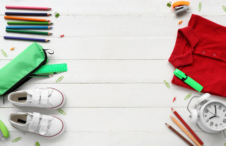 Different stationery with stylish school uniform on white wooden backgroundの写真素材