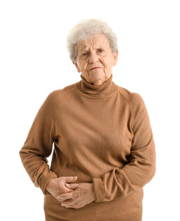 Senior woman with appendicitis on white backgroundの写真素材