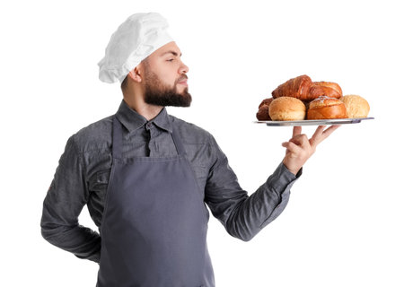 Male baker holding tray with pastries on white backgroundの写真素材