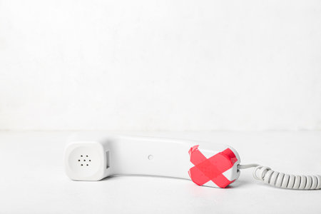 Taped phone receiver on white background. Censorship conceptの写真素材