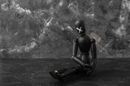 Taped mannequin on dark table. Censorship concept