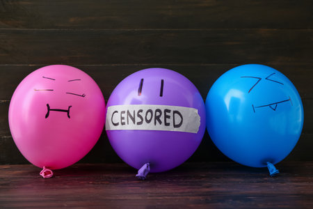 Balloons with word CENSORED on dark wooden backgroundの写真素材
