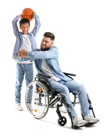 Little boy and his father in wheelchair with ball on white backgroundの写真素材