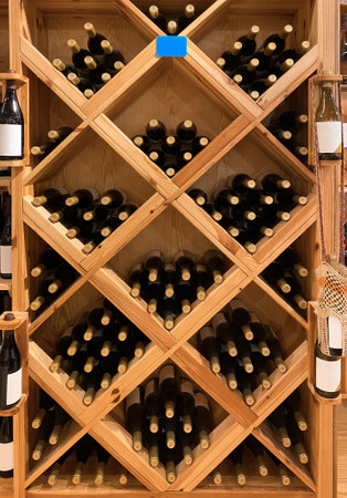 Wooden storage stand with bottles of wine in storeの写真素材