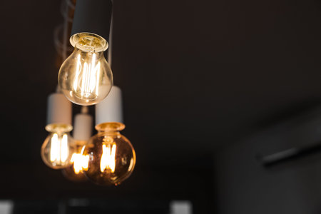 Glowing light bulbs in dark room