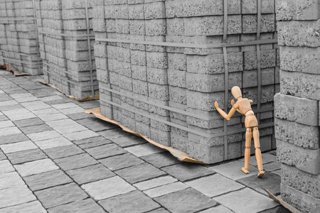 Wooden mannequin with paving stones outdoorsの写真素材