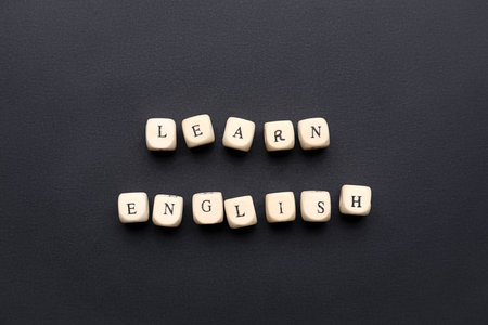 Cubes with text LEARN ENGLISH on black backgroundの写真素材
