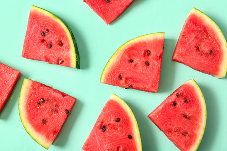 Pieces of fresh watermelon on turquoise backgroundの写真素材