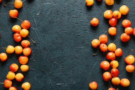 Many sweet yellow cherries on dark backgroundの写真素材