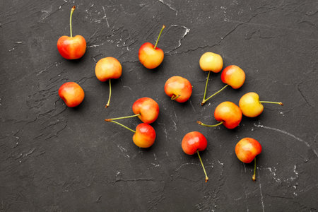 Many sweet yellow cherries on black backgroundの写真素材