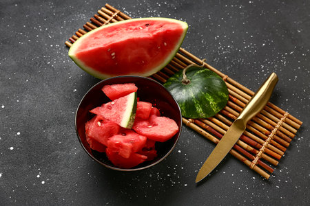 Bowl with pieces of fresh watermelon on black backgroundの写真素材
