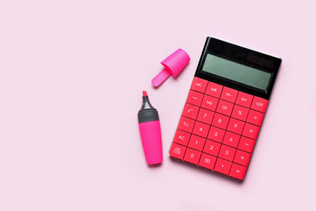 Modern calculator with marker on pink backgroundの写真素材