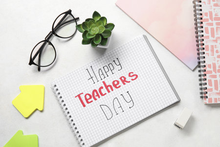 Notebooks with text HAPPY TEACHERS DAY, eyeglasses and sticky notes on white backgroundの写真素材
