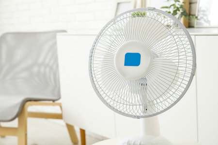 Modern electric fan on table in interior of living roomの写真素材